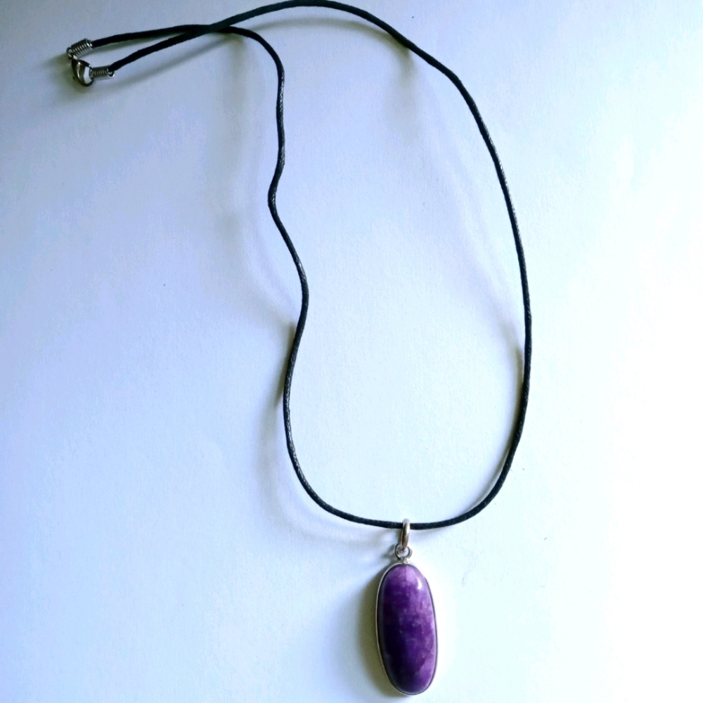 Rare purple gemstone on leather cord